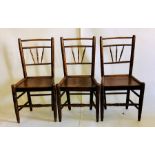 Two sets of three George III elm harlequin chairs, turned spindle backs, panelled seating, raised on