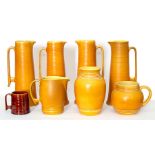 A set of four Bretby Art Pottery tapered tall beer jugs in the Art Deco manner along with