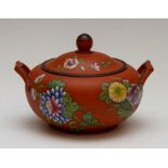 A Wedgwood Rosso Antico lidded sucrier, circa 1810-20. It is decorated with floral motifs