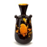 A Bretby Art Pottery large vase with two lug handles. The body has moulded decoration of two birds