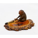 A Bretby Art Pottery tromp l'oeil dish, surmounted with a monkey and burning cigarette, No.1823,