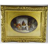 A porcelain oval framed wall plaque, 19th Century, depicting a people in a tavern playing cards,