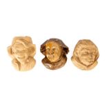 A collection of three Bretby art pottery bluff wall pockets modelled as human faces. Nos. 888, 887