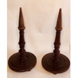 A pair of 18th century oak church candle holders, turned supports on circular moulded base. (2)