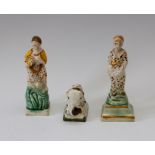 An early nineteenth century prattware lion and two similarly decorated square-based figures, circa