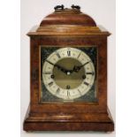 An early 19th Century figured walnut 8-day mantel clock, brass handles and keyhole, square brass