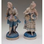 A pair of Continental figures, 19th Century, depicting and lady and gentleman, both holding head