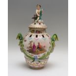 A 19th Century Berlin porcelain pot pourri vase and cover, infant with bird finial to the pierced