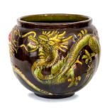 A Bretby Art Pottery large jardiniere with moulded dragon decoration picked out in naturalistic