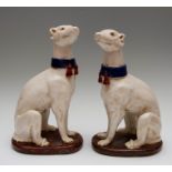 A pair of Staffordshire type greyhound dog figures, each looking up, 36cm high, unmarked to base,