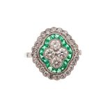 A diamond and emerald cluster ring, comprising quatrefoil of collet set round brilliant cut diamonds