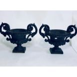 A pair of 19th century campagna cast iron urns, egg and dart trim shape with scrolled handles,