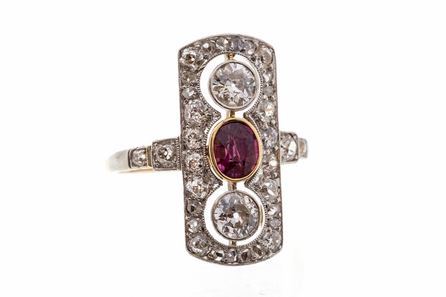 A ruby and diamond 18ct yellow gold and platinum ring, Art Deco styling, comprising  an oval ruby,