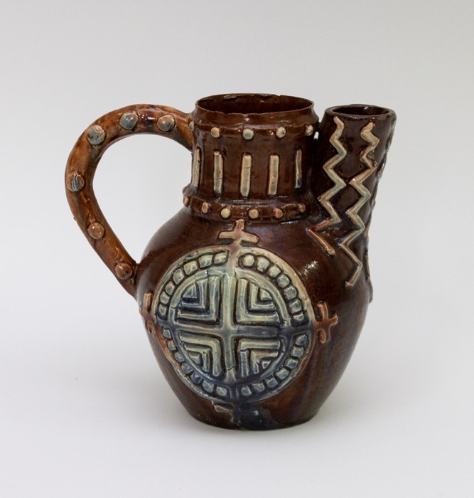 A late nineteenth century Castle Hedingham Pottery Art Pottery handle jug/teapot, circa 1880. It has