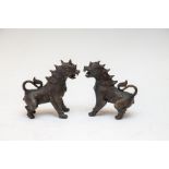 A pair of oriental bronze rampant standing beasts, 20th Century, height 13cm (2)