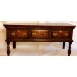 An early George III oak dresser base, circa 1760, rectangular top above moulded edge, fitted with
