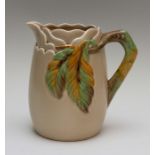 A Clarice Cliff pitcher, moulded branch and leaf design on a beige ground, printed Newport Pottery