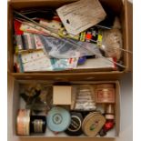 A box of haberdashery items to include hook eye, some vintage knitting needles, covered button