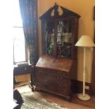 A George III mahogany glazed bookcase bureau, circa 1770, in the manner of Chippendale, crowned with