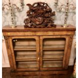 An early Victorian walnut and ormulu credenza, circa 1860, moulded cornice with satinwood floral