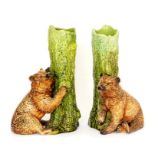 A pair of Bretby Art Pottery spill vases in the majolica style well-modelled as a bear standing next