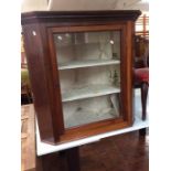 A 19th Century mahogany glazed corner cabinet, having a single door enclosing two fitted shelves