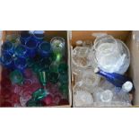 A collection of assorted glassware, including coloured drinking glasses, clear wine glasses,