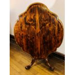 An early Victorian rosewood tilt top centre table, circa 1850, serpentine shape top, above a