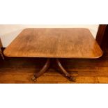 A Regency mahogany breakfast table, circa 1815, rectangular tilt-top with rounded corners and a