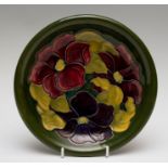 A Moorcroft clematis plate, impressed marks and green W.M initials, diameter 21cm