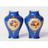 A pair of Royal Worcester vases, early 20th Century, of inverted baluster form, each with still life