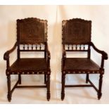 A pair mid 18th Century oak leather hall chairs, circa 1750, brass stud fitted leather back inlay of