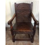 A Carolean style joined oak Wainscot armchair, 19th Century, incorporating earlier timbers, carved