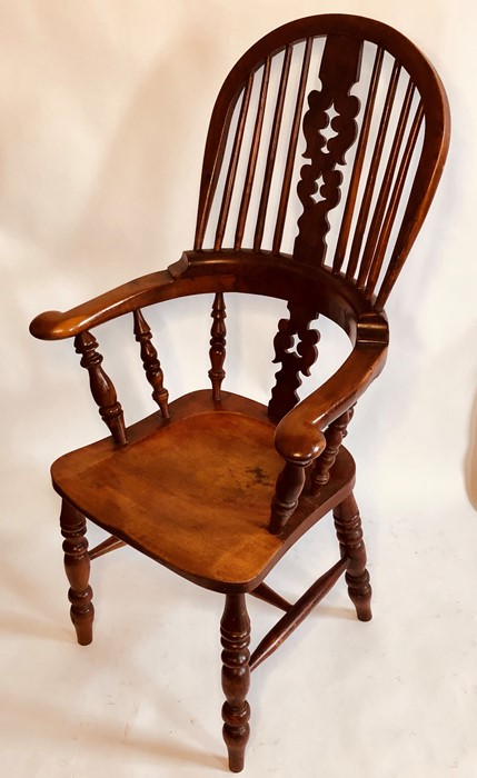 A George III elm and yew wood high back Windsor armchair, circa 1820, sparred back with pierced vase