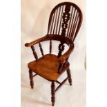 A George III elm and yew wood high back Windsor armchair, circa 1820, sparred back with pierced vase