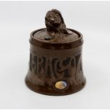 A Bretby art pottery bronzed and jewelled tobacco jar and cover, the finial in the form of an Art