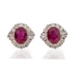 A pair of ruby and diamond 18ct white gold cluster studs earrings,  comprising oval rubies claw