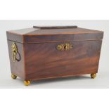 A George III mahogany tea caddy, circa 1800, sarcophagus form inlaid boxwood stringing, enclosing