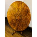 A mid 19th Century Victorian burr and figured walnut tilt top loo table, circa 1850, oval top with