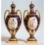 A pair of Mintons hand painted two handled vases, early 20th Century, each with a panel of