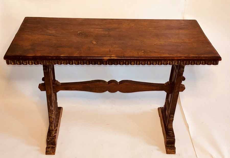 A 17th Century Spanish walnut and oak trestle table, rectangular top with dentil carved edge,