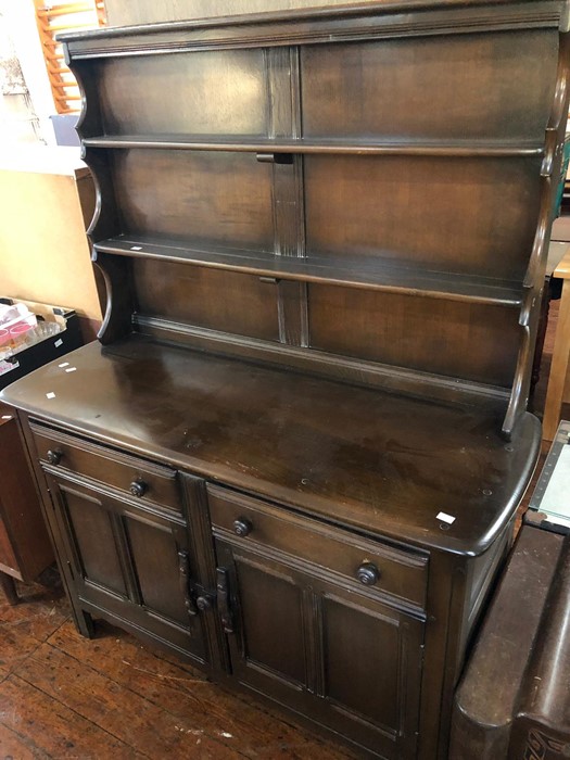 An Ercol elm dresser and rack, two tier shelving above two short drawers and two cupboards.