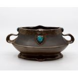 A Bretby art pottery bronzed and jewelled twin-handled planter, No. 1627. 24 cm wide. Condition: