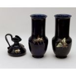 A pair of Bretby Art Pottery blue glazed baluster vases, applied insects, height 30cm, and a low jug