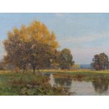 Edward Wilkins Waite (British, 1854-1924), a river landscape in autumn with cattle grazing, signed