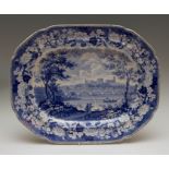 An antique pottery blue and white transfer printed platter, circa 1825. It is decorated with a