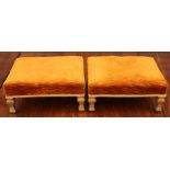 A pair of early 19th Century giltwood footstools, in the French taste, gold upholstery, raised on