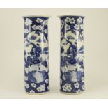 A pair of 19th Century Chinese hand-painted under-glaze tall blue and white vases with splayed rims,