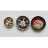 Three Moorcroft miniature round low bowls, patterns to include two columbine and one hibiscus,