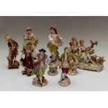 A collection of assorted German figures, depicting ladies and gentleman in various poses, together